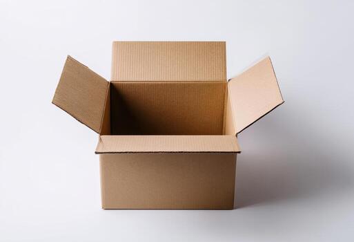 Open, empty corrugated cardboard box centered on a plain white surface, lit photo