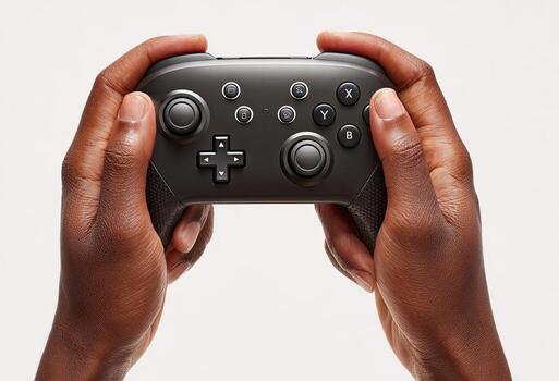 Dark-skinned hands gripping a charcoal-grey game controller against a clean white background photo