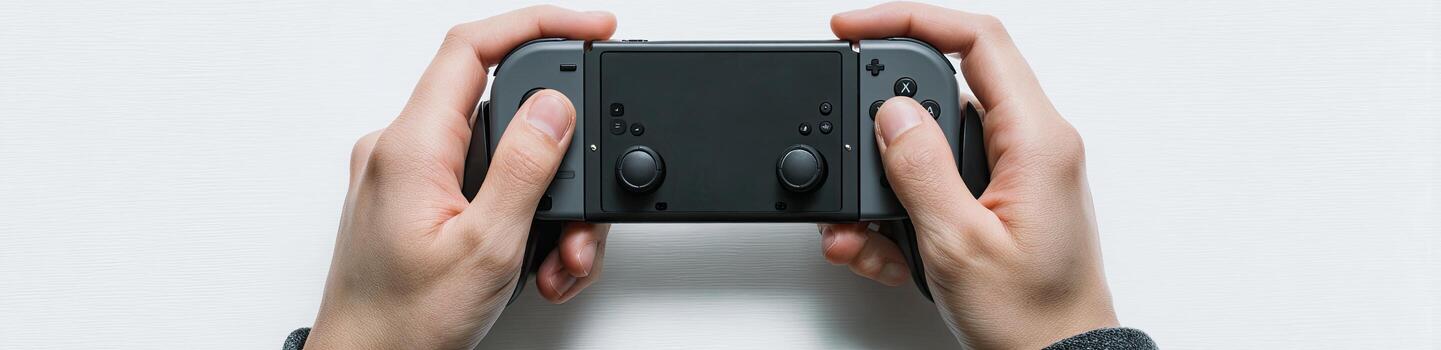 Hands holding a handheld game console centered against a white background photo