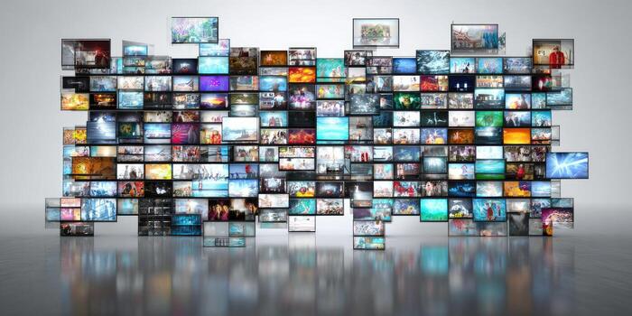 Array of screens displaying diverse content, reflection below. White background and a sense of media photo