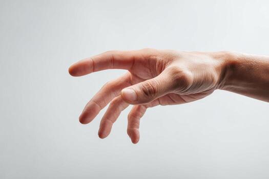 A human hand, palm up, slightly curved and reaching, set against a plain light background photo