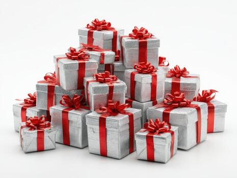 Stack of silver wrapped presents with red ribbon bows against a white background photo