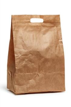 Isolated, upright, brown paper bag with a rectangular handle cutout on white photo