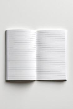 An open, lined notebook lies flat, centered on a white surface, showcasing blank pages photo