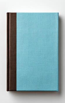 Overhead view of a hardcover book with a teal cover and brown spine on a white surface photo