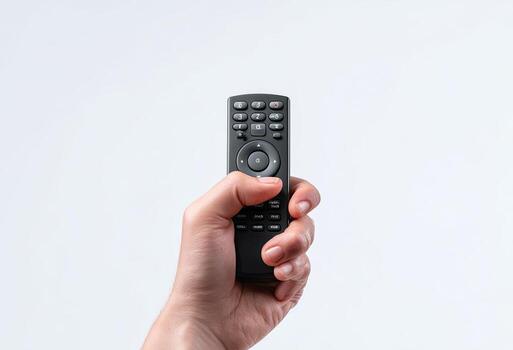 mano agarre un oscuro, rectangular remoto controlar en contra un llanura blanco fondo foto