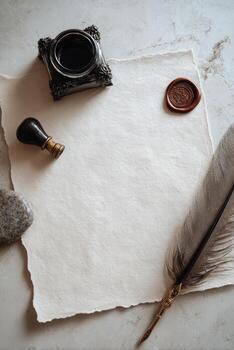 Vintage writing setup with feather, parchment, inkwell, wax seal, stone and paper photo