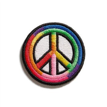 A circular patch with the peace symbol, outlined in black, with a rainbow-colored inner circle photo