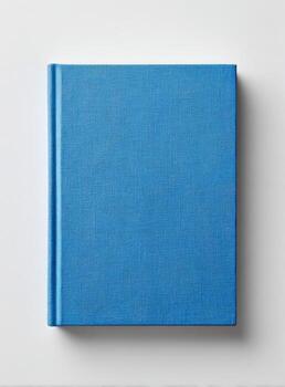 Overhead shot of a closed hardcover book with a textured blue cover on a plain white surface photo