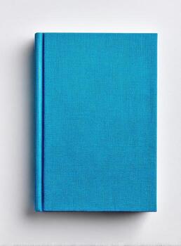 Overhead shot of a closed teal-colored book with a blue spine on a white background photo