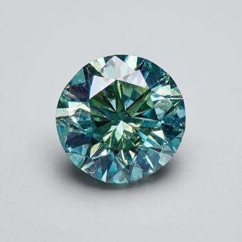 Close-up view of a round, faceted gemstone with teal, blue and green hues photo