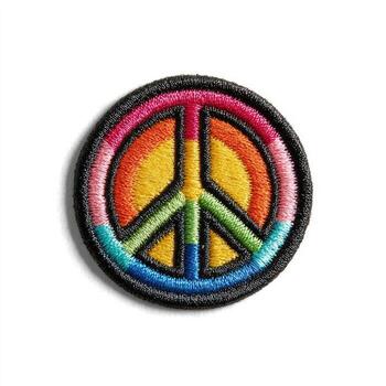 A patch with a peace sign in a rainbow color photo