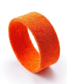 Orange fabric ring. A vibrant orange, textured fabric ring, circular and smooth, lies on a white background photo
