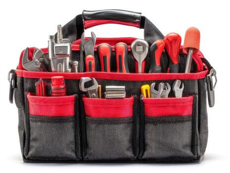 Red and black tool bag overflowing with assorted tools photo