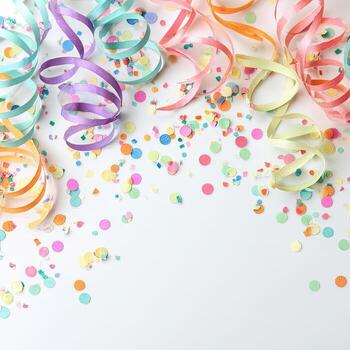 Colorful confetti and streamers in various pastel colors cascade over a white backdrop photo