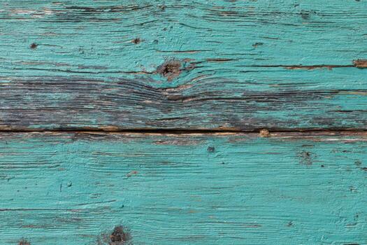 Close-up of weathered, turquoise painted wood planks with visible knots and grain photo