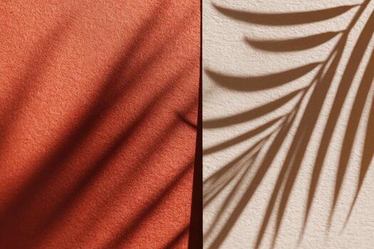 Flat-lay of coral and beige surfaces with palm leaf shadows, creating abstract shapes photo