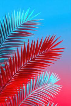 Neon lit palm fronds in vibrant red and cyan against a gradient blue to pink backdrop photo