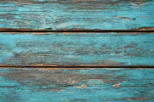 Close-up of weathered, horizontal wooden planks painted in teal with visible grain and cracks photo