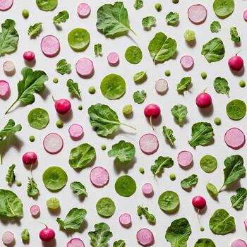 Overhead view of a vibrant, patterned arrangement of fresh vegetables on a white backdrop photo