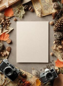 A centered blank card surrounded by autumn leaves, cameras, maps, acorns, and pinecones photo