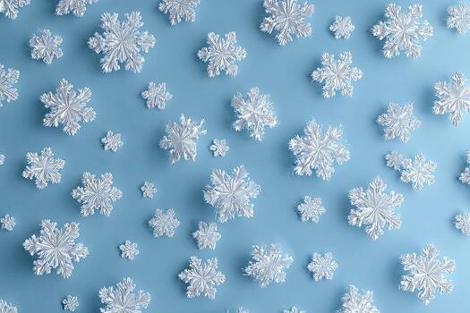 Close-up of many glittering snowflakes scattered across a light blue surface photo