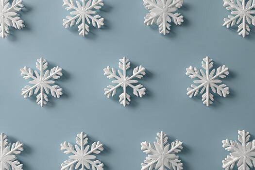 Close-up of white, textured snowflakes arranged in rows on a muted, pastel blue background photo