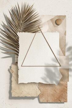 Earthy, layered composition with a geometric frame, textured paper, and a dry palm leaf photo