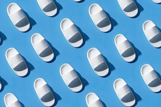 Array of white cushioned slides cast shadows on a blue surface, suggesting rest photo