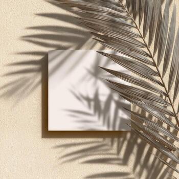 Square white card on textured beige surface, palm leaf shadow creating natural aesthetic photo