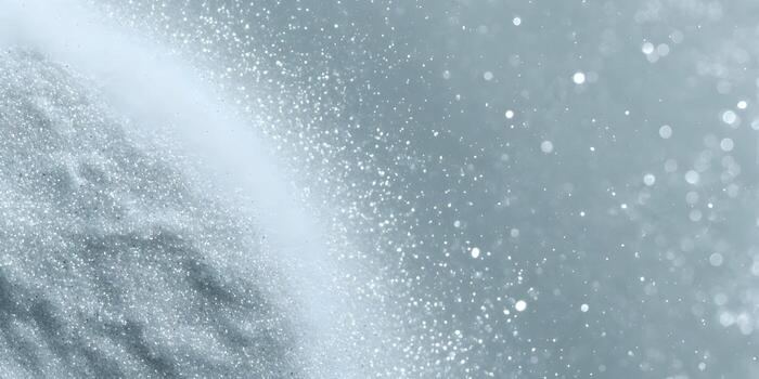 A sparkling glitter texture transitions into soft bokeh light particles creating an abstract elegant background photo