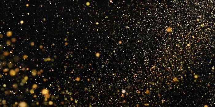 Sparkling golden particles float gracefully on a dark black background creating an elegant festive and luxurious abstract design photo