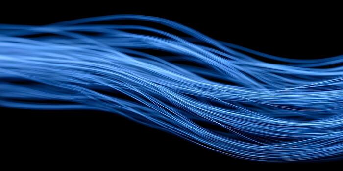 Bright blue flowing lines depict data transmission and technology in an abstract dark background photo