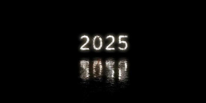 The year 2025 is displayed in bright sparkling particles reflecting on a dark wet surface photo