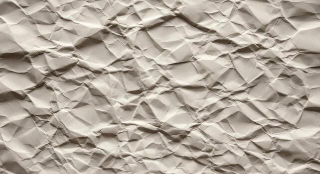 Close up view of textured crumpled paper with deep shadows and highlights photo