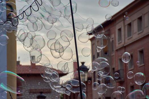 Hundreds of soap bubbles floating in the air, creating an ephemeral spectacle of colors and reflections photo