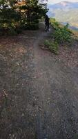 Mountain biker navigating a winding trail with stunning views and dynamic motion sequence video