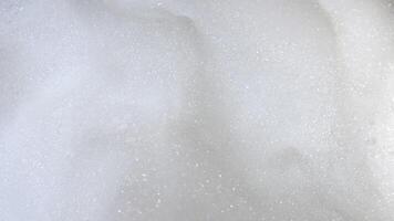 Foam bubble from soap or shampoo top view. Soap foam texture surface for white abstract background. Detergent foam. Copy space, banner. For laundry, cleaning service. Bathroom, clean, wash concept. video