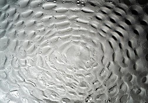 Textured surface of the moon in extreme close-up, revealing geological features and crater patterns used in astrophotography, astronomy education, and science-themed digital or editorial compositions photo