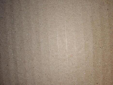 Close-up of brown corrugated cardboard surface with soft focus. Useful as a background, texture, or design material for packaging, eco, and craft concepts photo