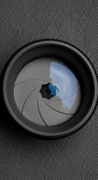 A camera lens with a blue reflection photo