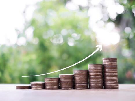 Stack of coins with arrow rising. The concept of saving money to success business in the future photo