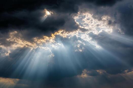 Sunbeams shining through clouds in the sky photo