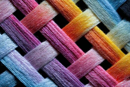 A close up of a woven fabric with many different colors photo