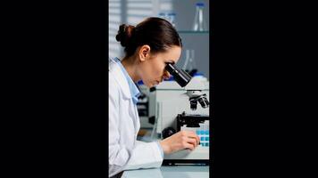 Scientist in Laboratory Using Microscope for Research and Analysis video