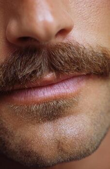 Close-up of man with brown mustache and stubble photo
