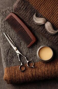 Men's grooming tools including comb, scissors, mustache wax photo