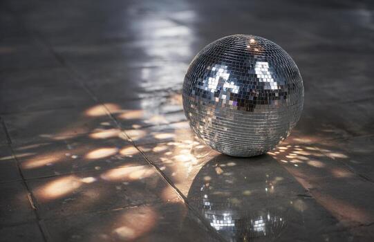 Disco ball reflecting light creating patterns on floor photo