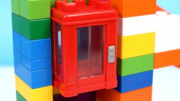 Building a Tall Colorful Tower With Elevator Using Toy Construction Blocks at Daytime video