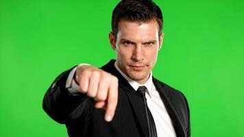man i kostym på grön skärm är pekande ner med arg uttryck video